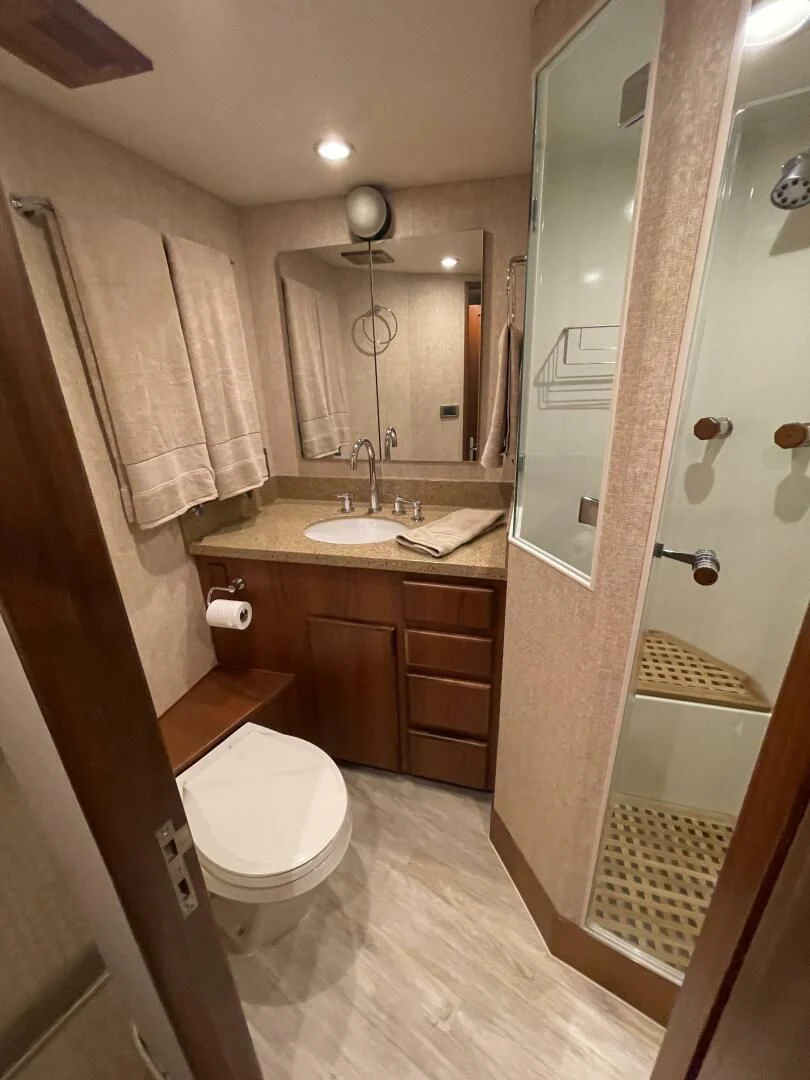 a bathroom with a sink toilet and a mirror aboard SEA LION Yacht for Sale