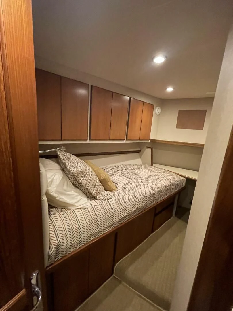 a bed with a white cover aboard SEA LION Yacht for Sale