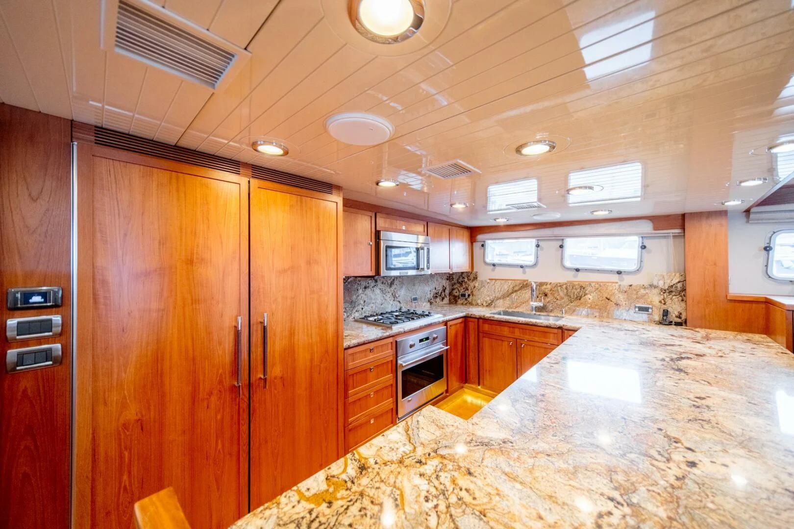 a kitchen with wooden cabinets aboard SEA LION Yacht for Sale