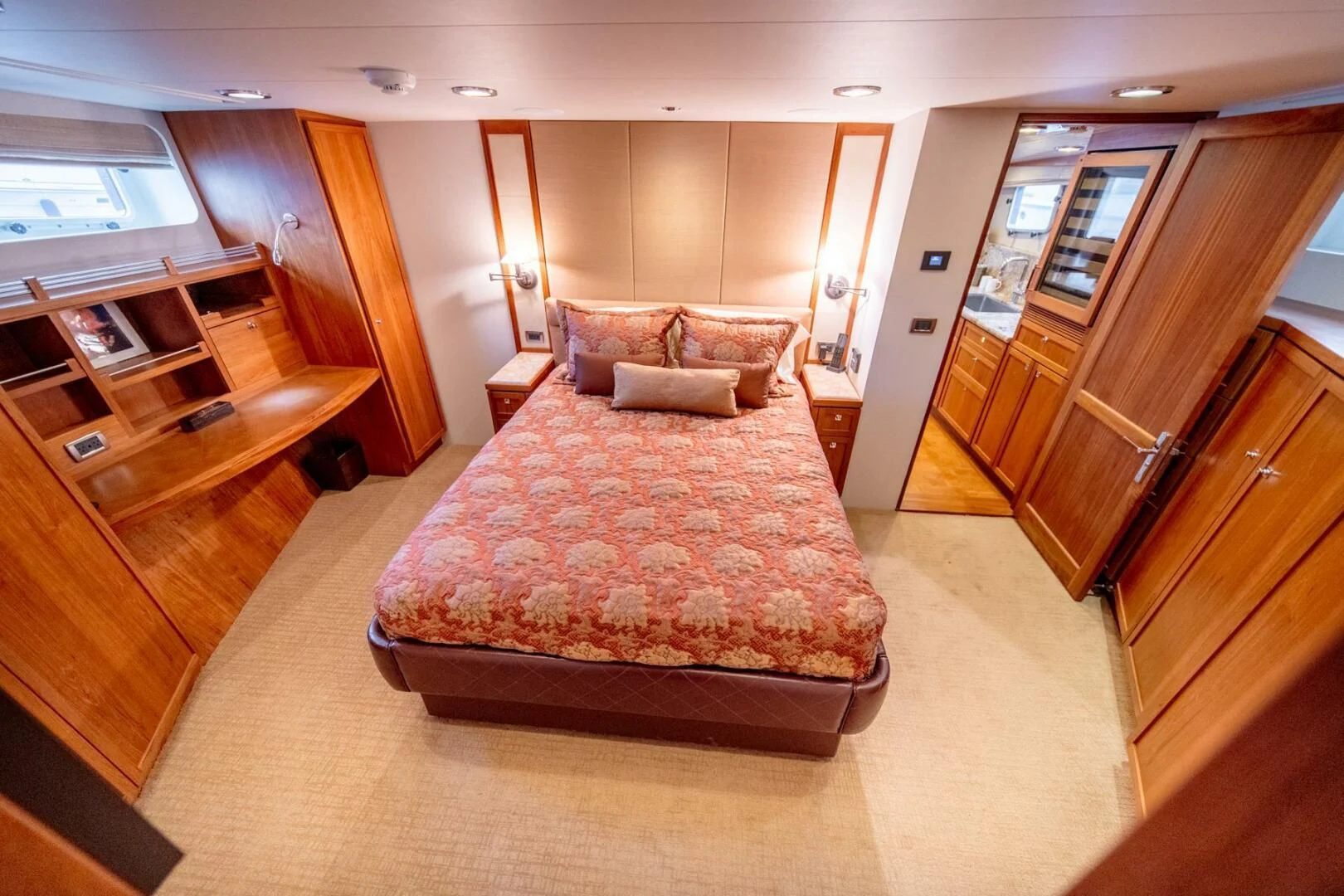 a bedroom with a bed and a desk aboard SEA LION Yacht for Sale