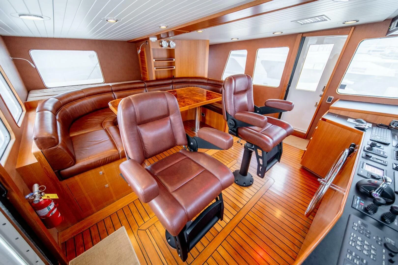 a living room with leather furniture aboard SEA LION Yacht for Sale