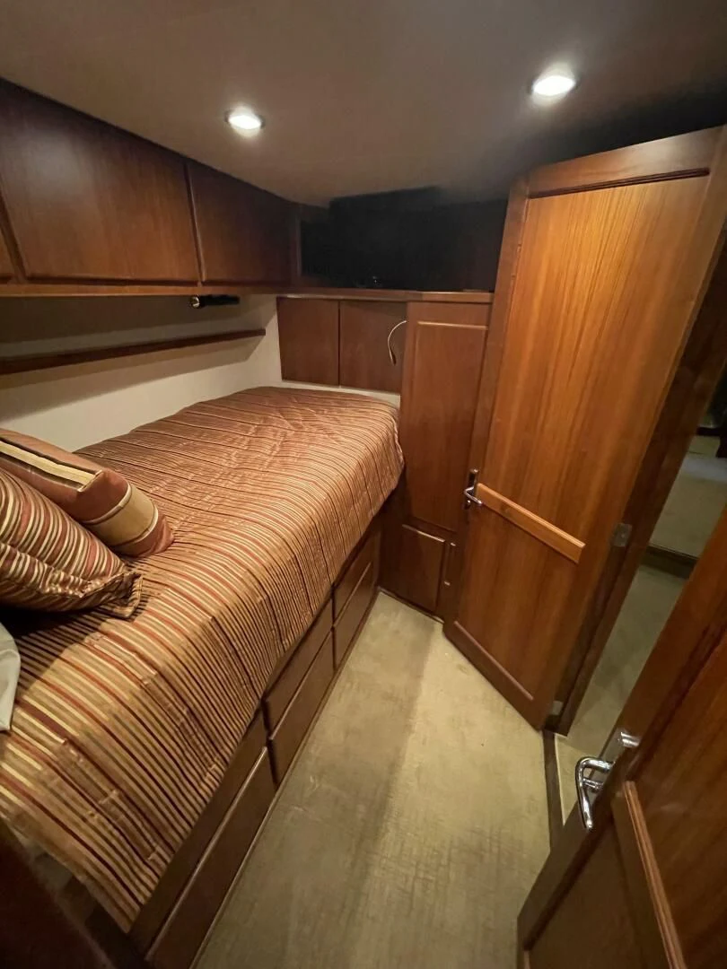 a bedroom with a bed and cabinets aboard SEA LION Yacht for Sale