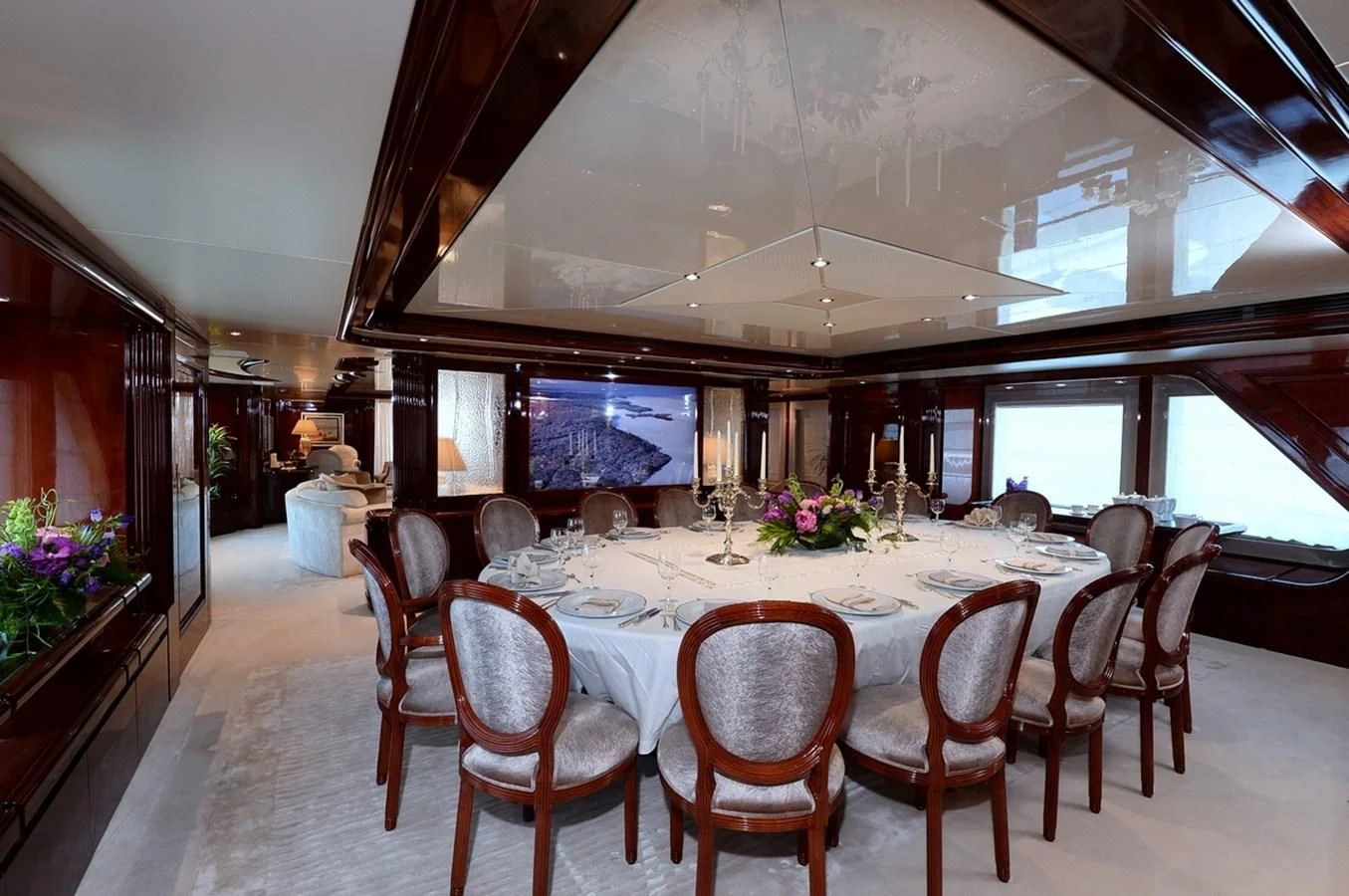 a large dining table in a room aboard SUITE Yacht for Sale