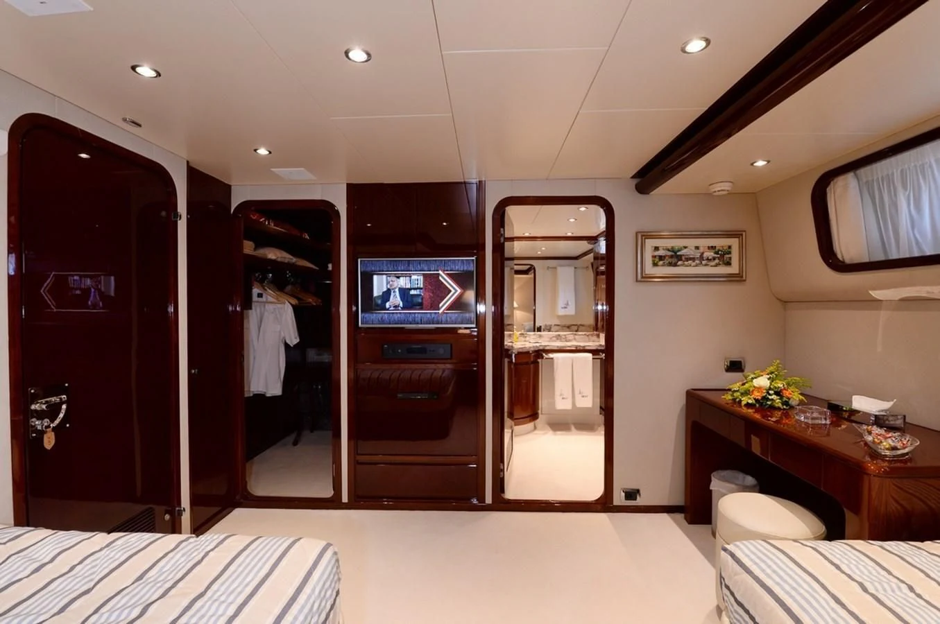 a room with a bed and a desk aboard SUITE Yacht for Sale