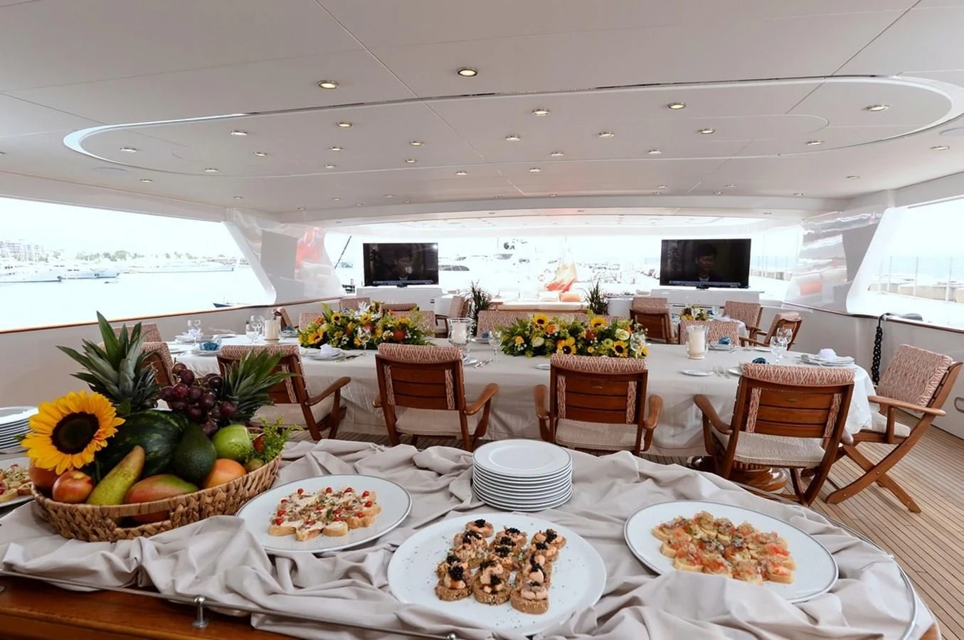 a table with plates of food aboard SUITE Yacht for Sale