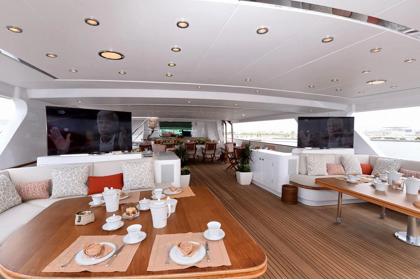 a living room with a large screen aboard SUITE Yacht for Sale