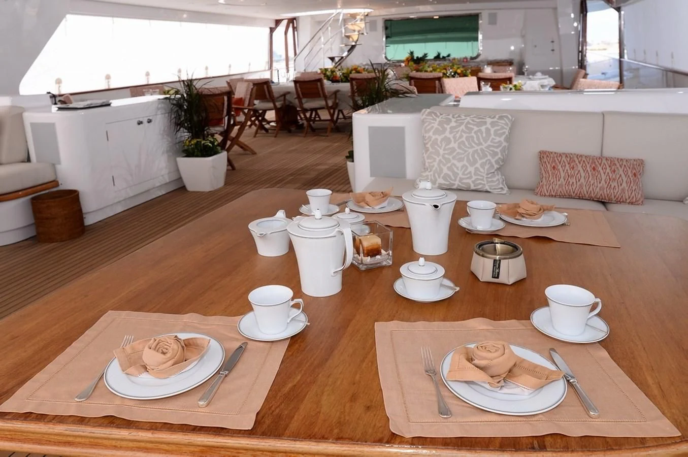 a table with plates and cups on it aboard SUITE Yacht for Sale