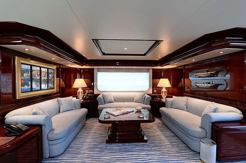 a living room with a large mirror aboard SUITE Yacht for Sale