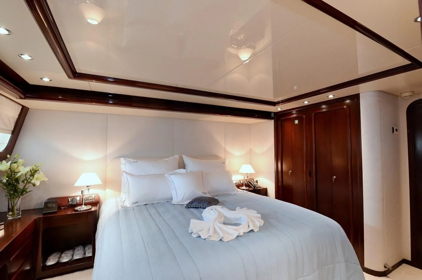 a bed with white sheets aboard SUITE Yacht for Sale