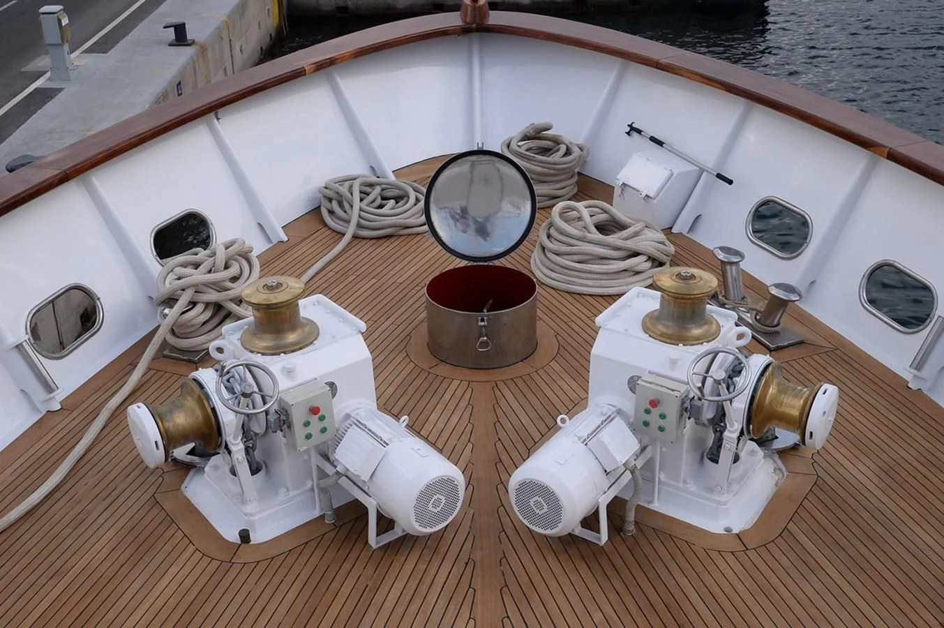 a wooden table with a white sink and a white rectangular object with brown liquid and a white surface aboard SUITE Yacht for Sale