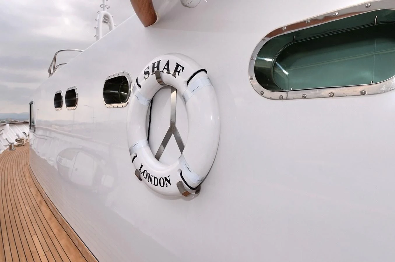 a white speedboat with a white logo on the front aboard SUITE Yacht for Sale