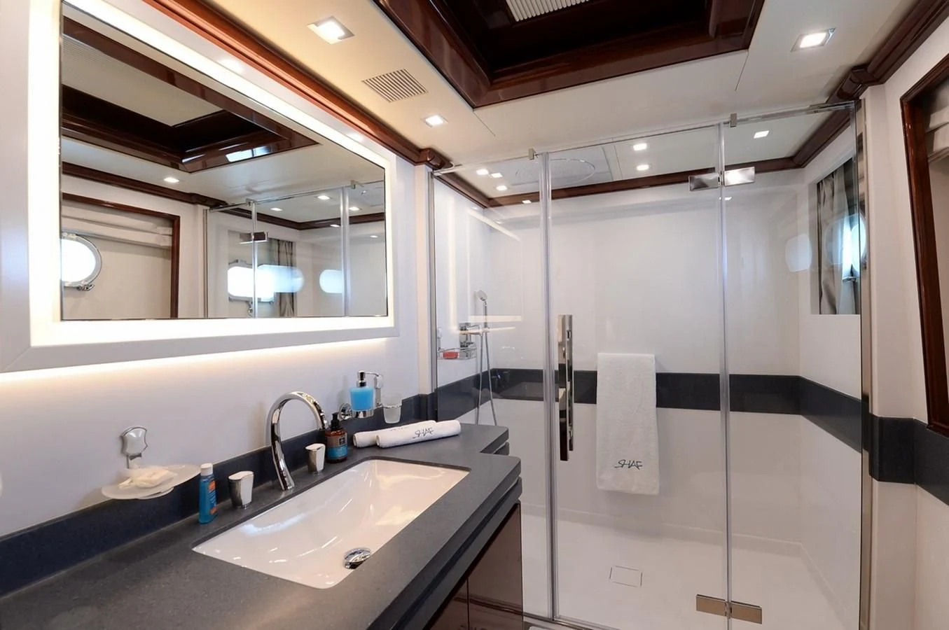 a bathroom with a glass shower aboard SUITE Yacht for Sale