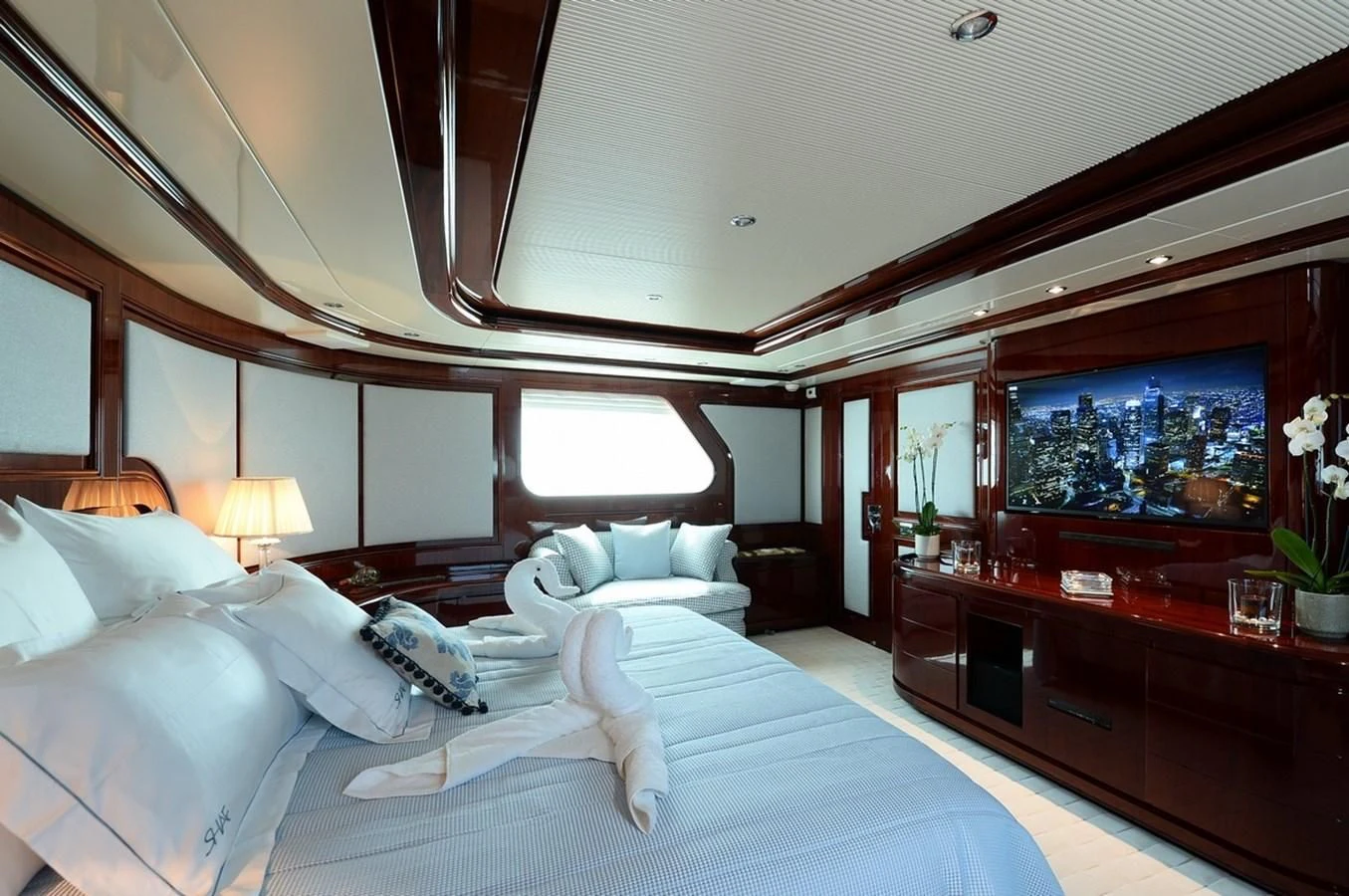 a room with a bed and a tv aboard SUITE Yacht for Sale