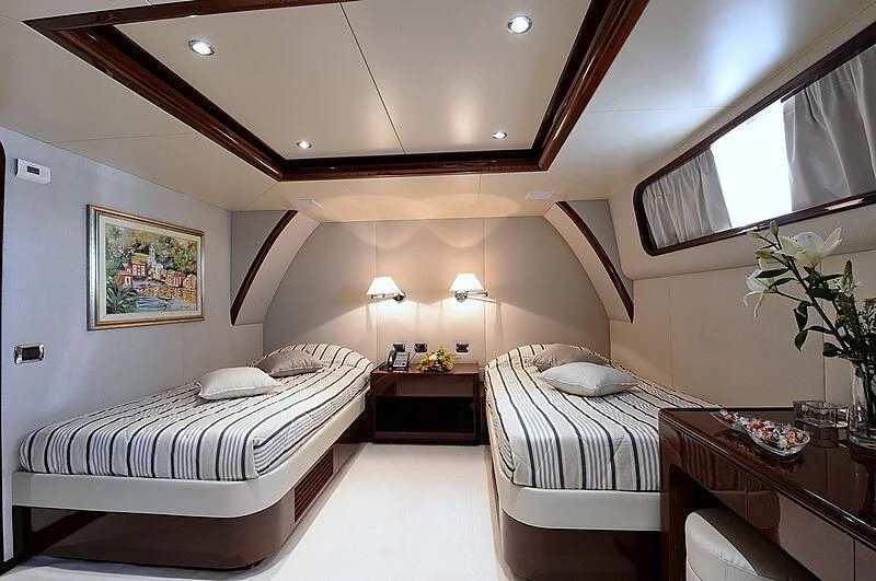 a room with two beds aboard SUITE Yacht for Sale