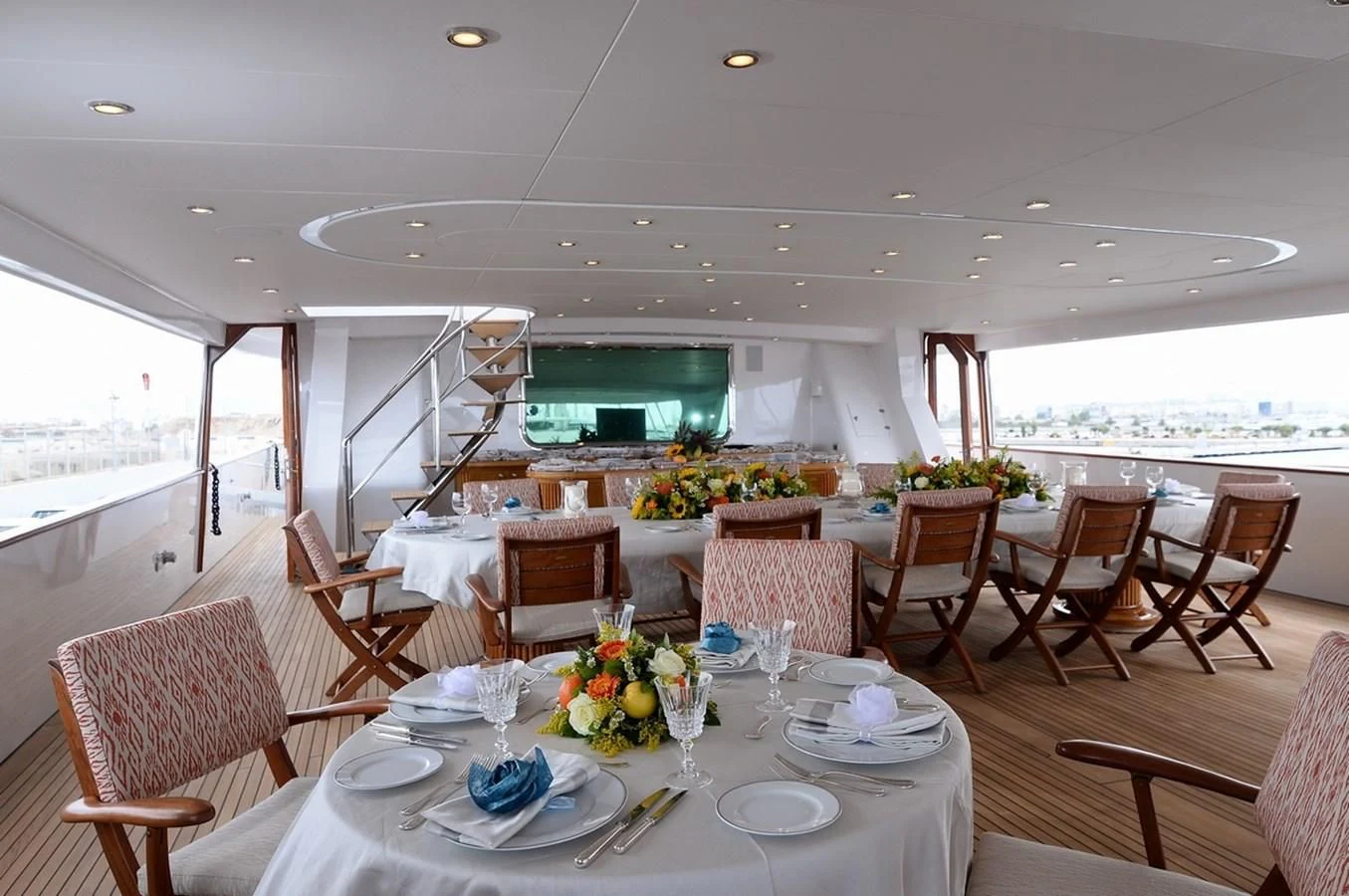 a dining room with a table set for a meal aboard SUITE Yacht for Sale