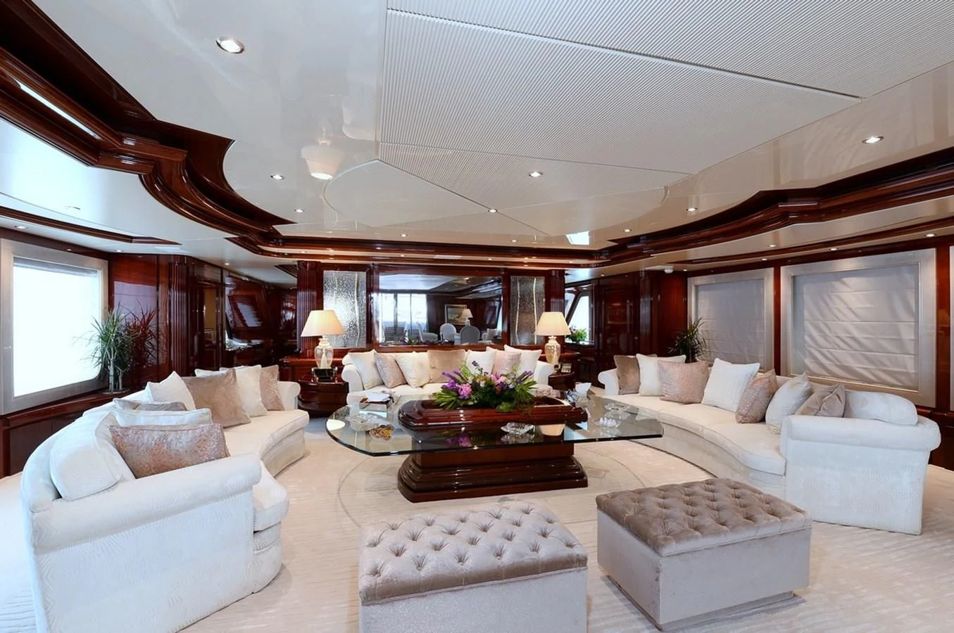 a living room with a large mirror aboard SUITE Yacht for Sale