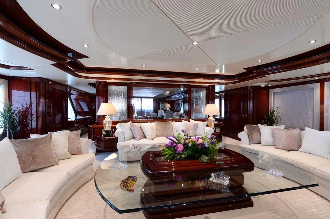 a living room with a large mirror aboard SUITE Yacht for Sale