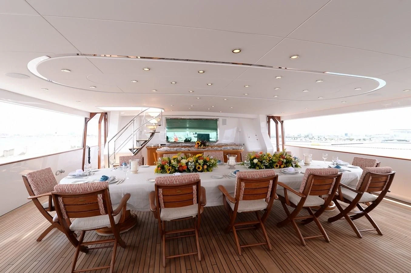 a room with a table and chairs aboard SUITE Yacht for Sale