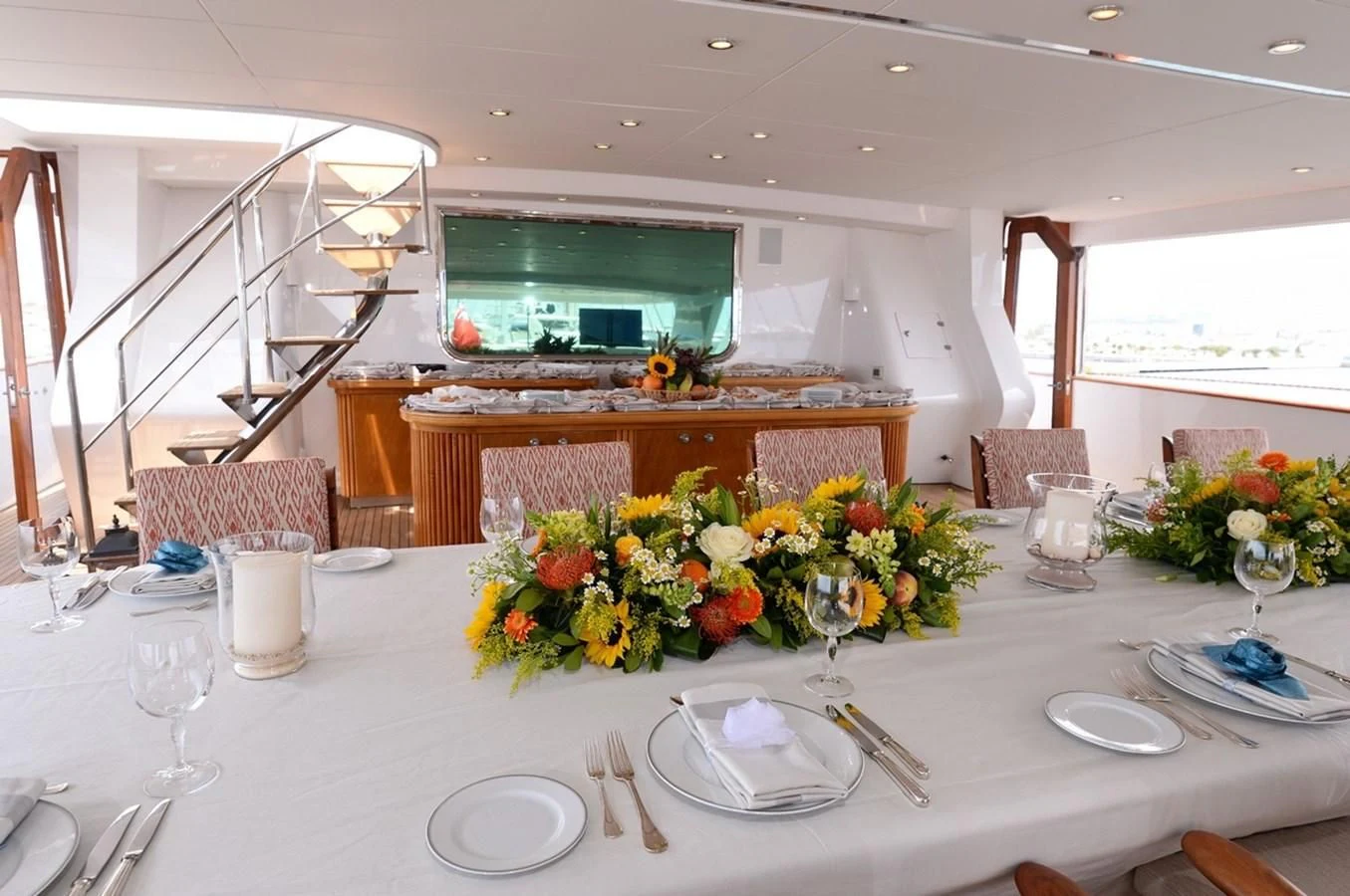 a table set with plates and glasses aboard SUITE Yacht for Sale