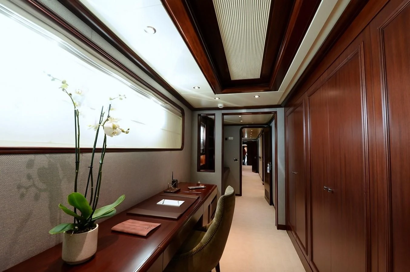 a room with a table and a plant in it aboard SUITE Yacht for Sale