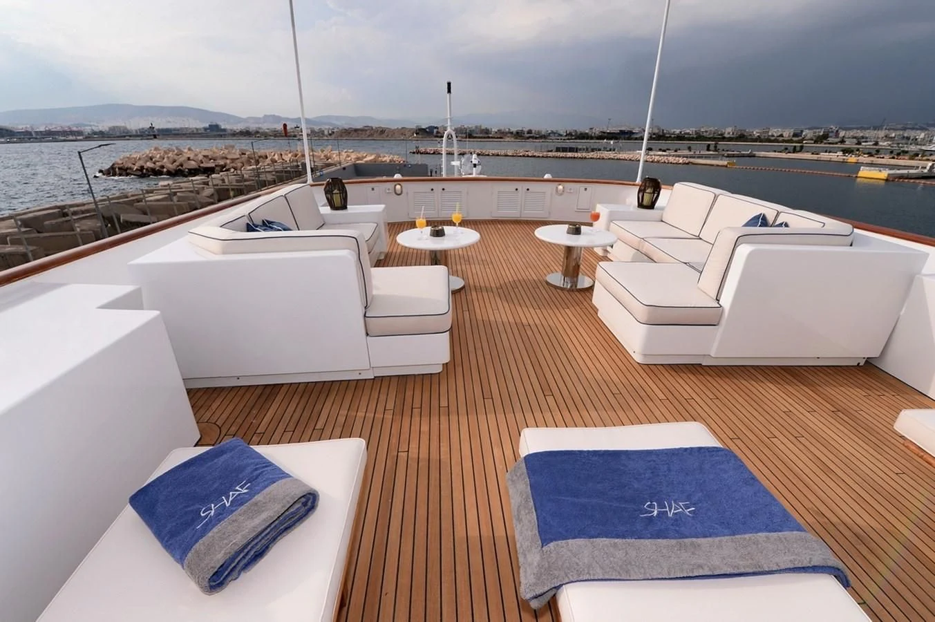 a room with a view of the water and a city aboard SUITE Yacht for Sale
