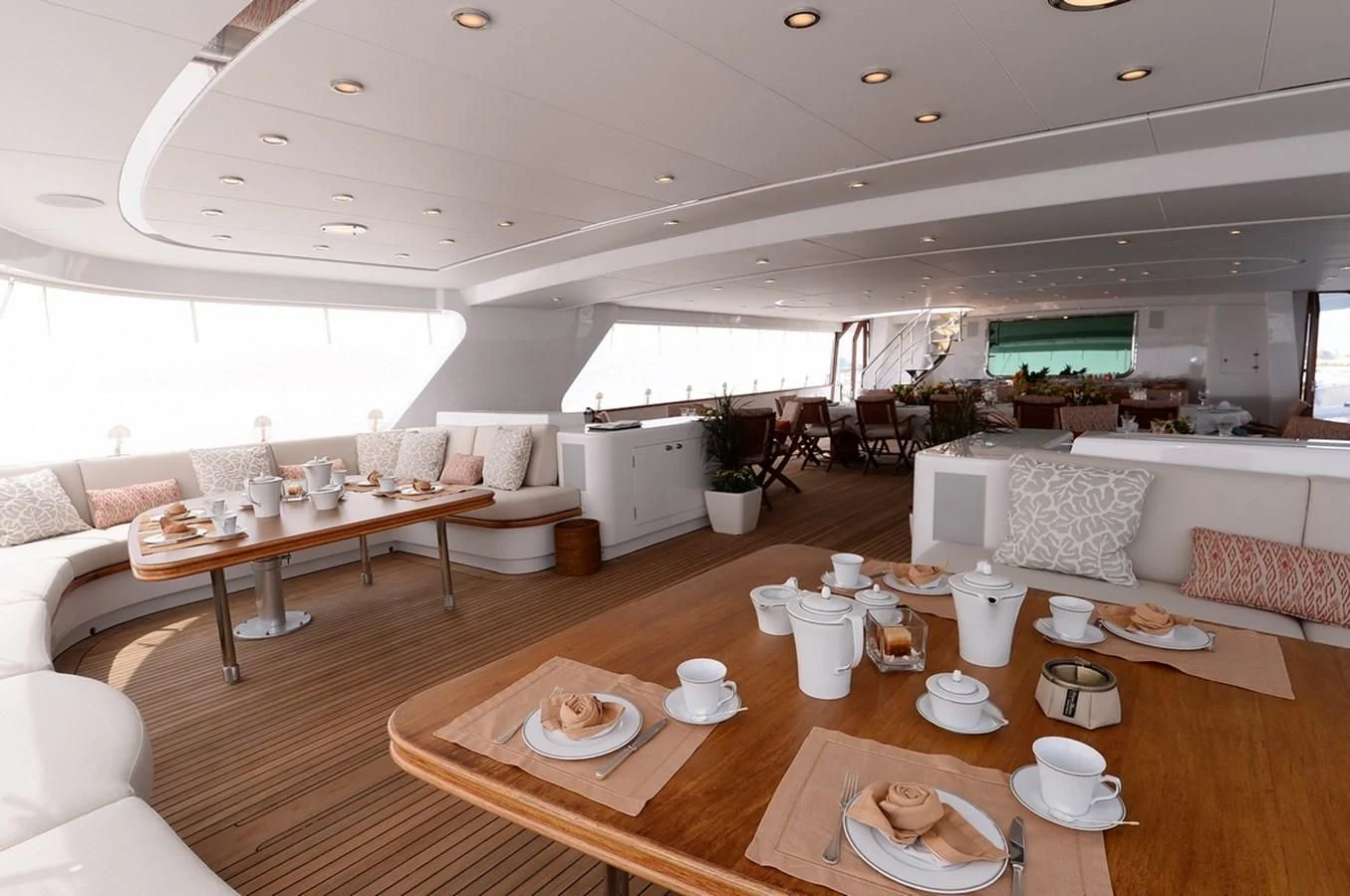 a living room with a table and chairs aboard SUITE Yacht for Sale