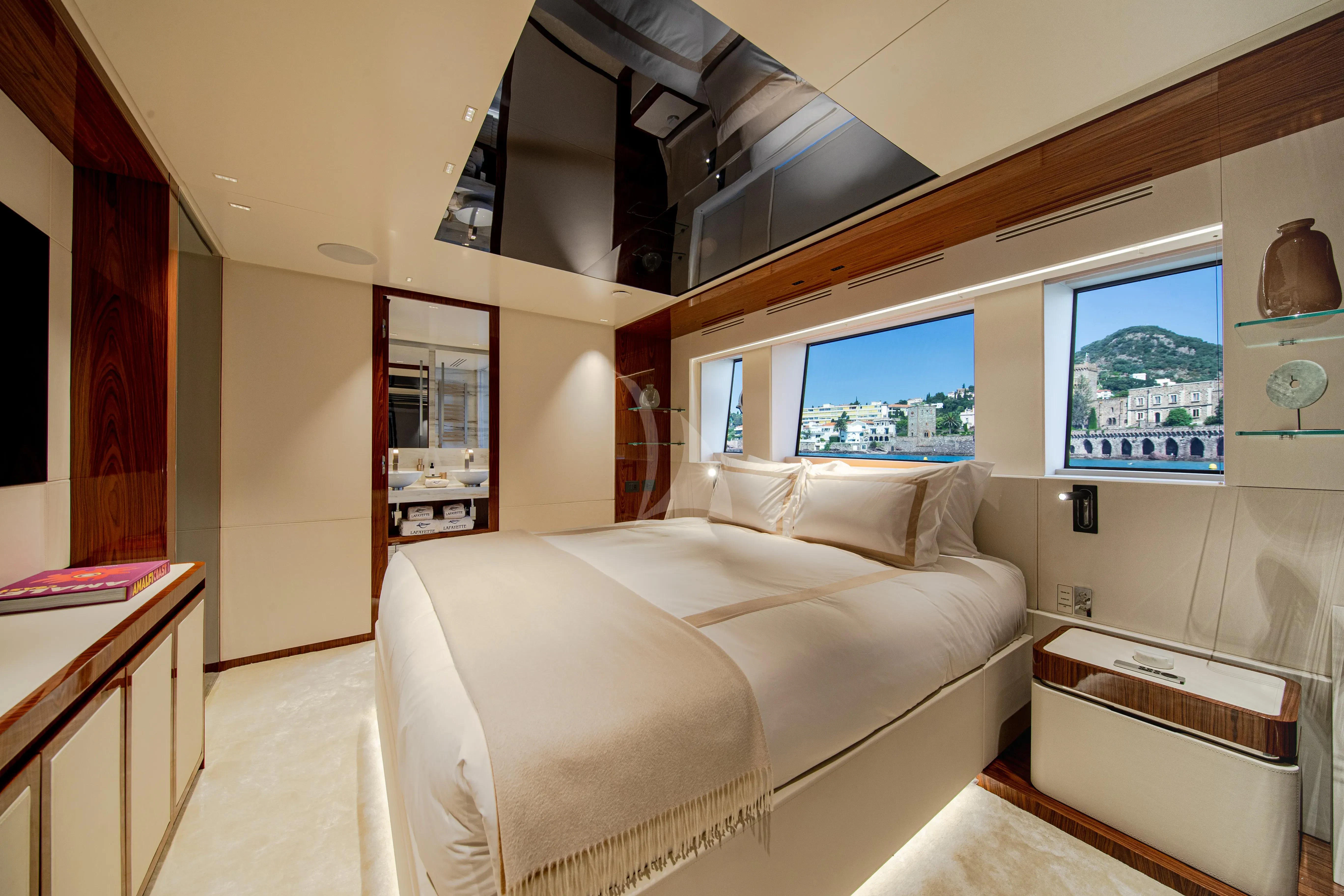 a room with a bed and a tv on the wall aboard LAFAYETTE Yacht for Sale