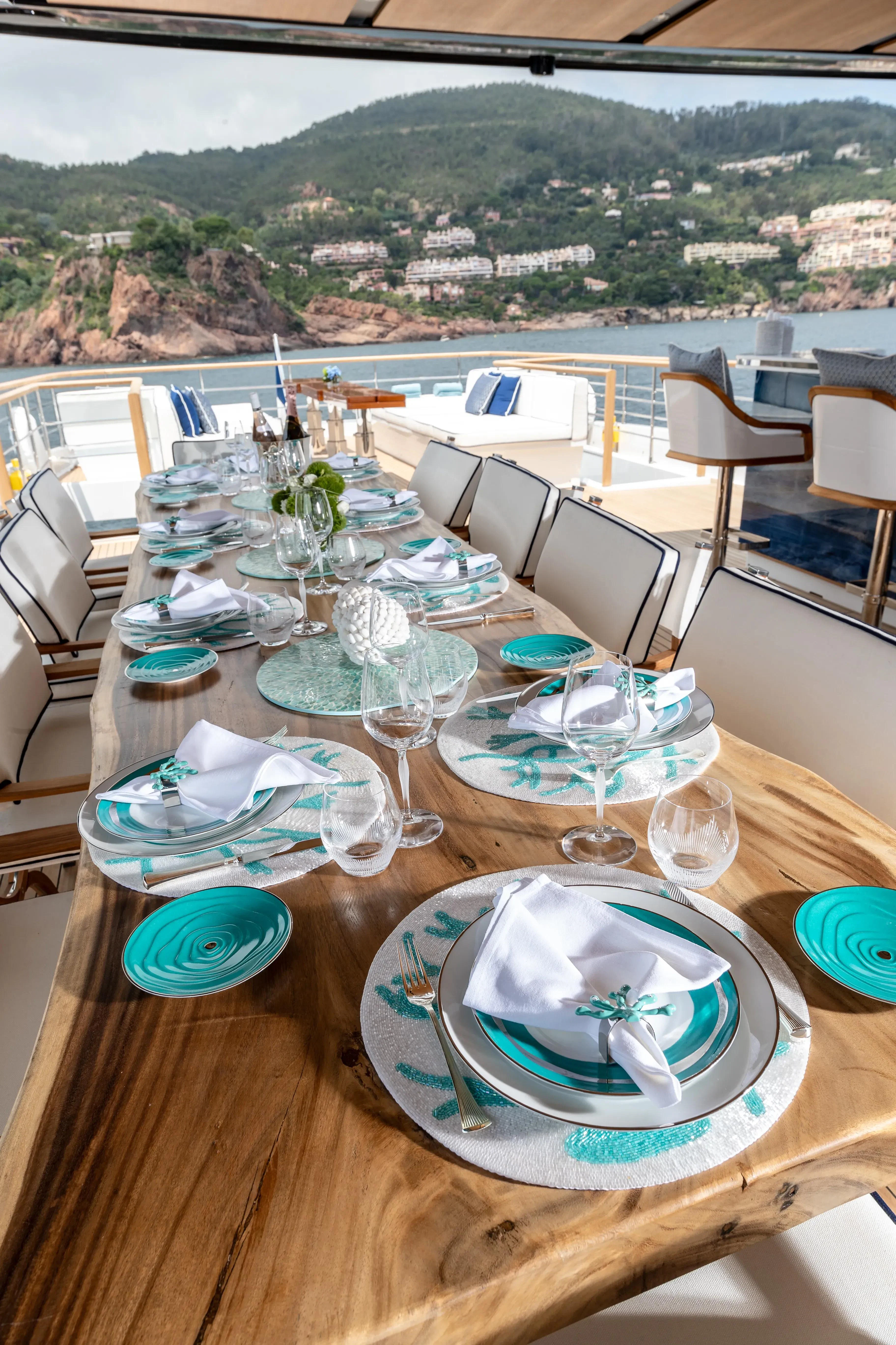 a table with plates and glasses on it aboard LAFAYETTE Yacht for Sale