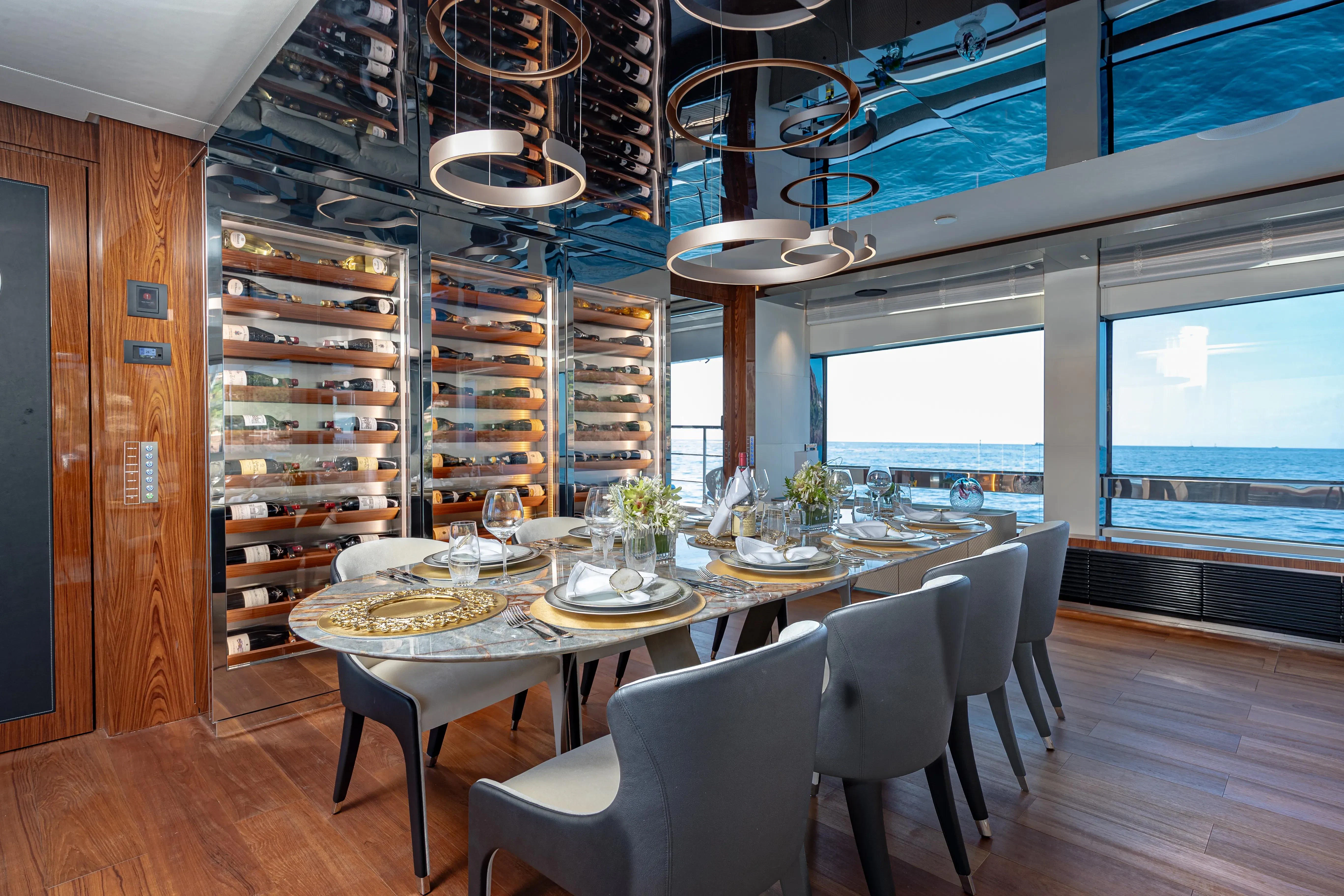 a dining room with a large window aboard LAFAYETTE Yacht for Sale