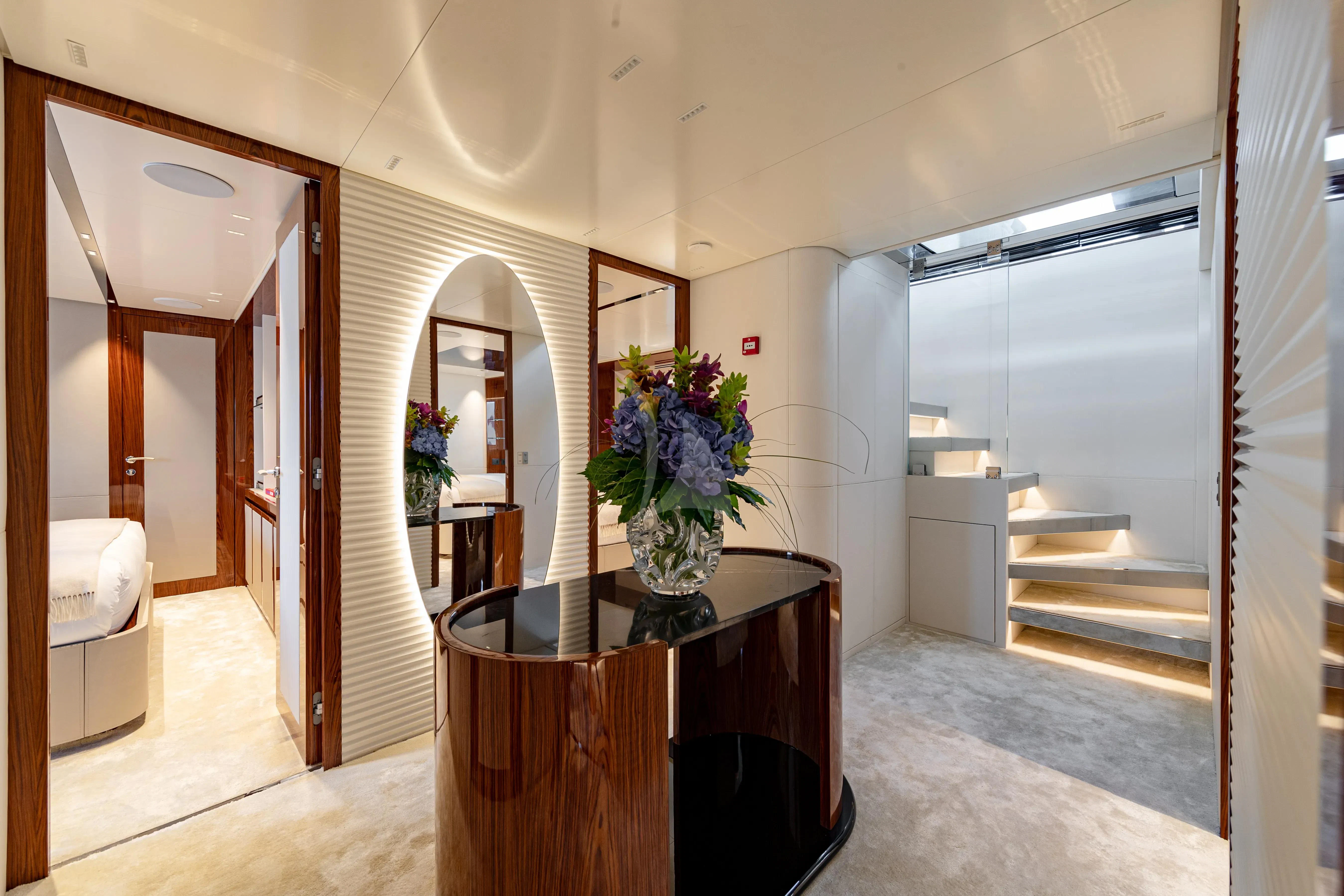 a large room with a table and a vase with flowers on a table aboard LAFAYETTE Yacht for Sale