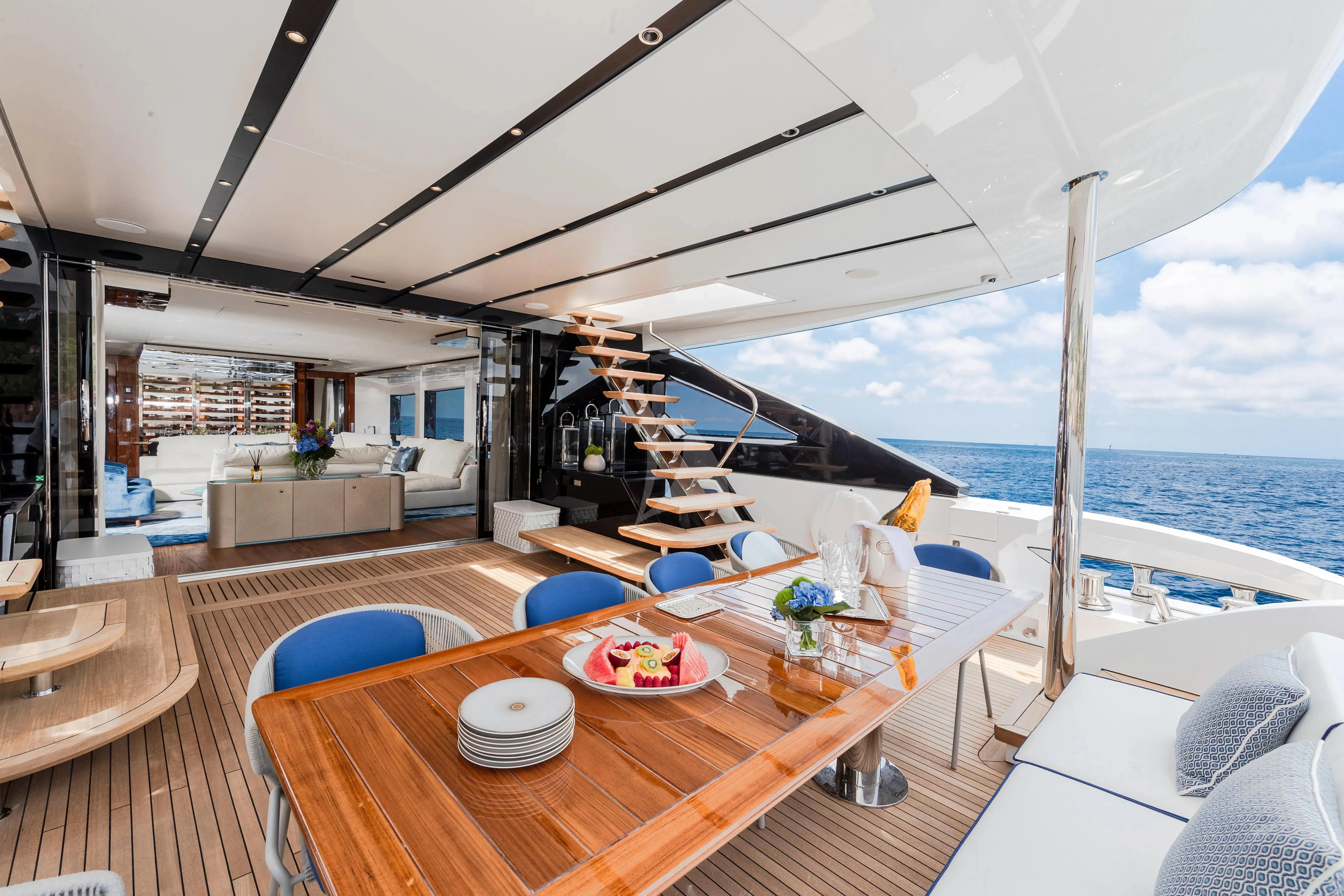 a large open space with a table and chairs and a large body of water aboard LAFAYETTE Yacht for Sale