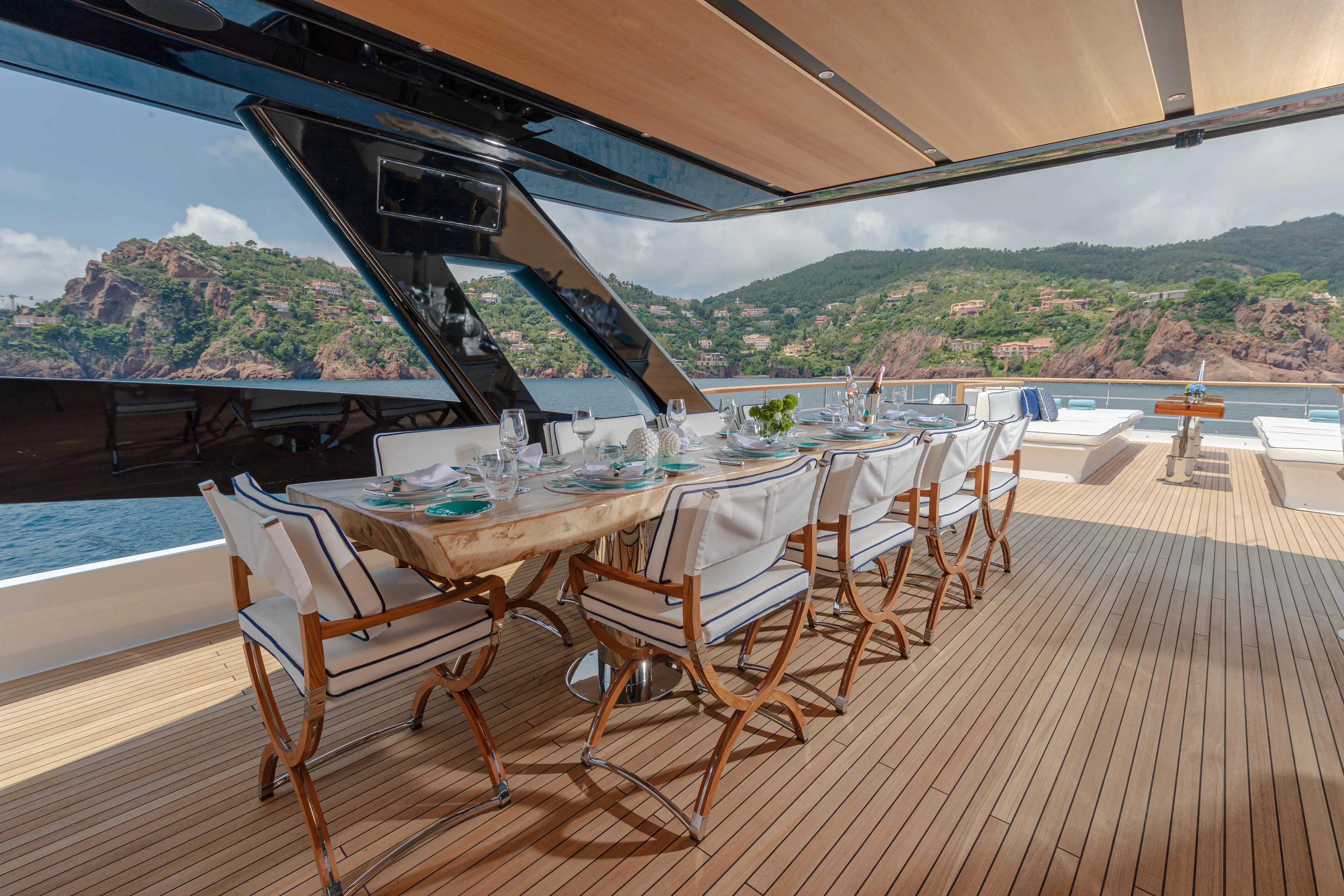 a table set for a meal on a deck aboard LAFAYETTE Yacht for Sale