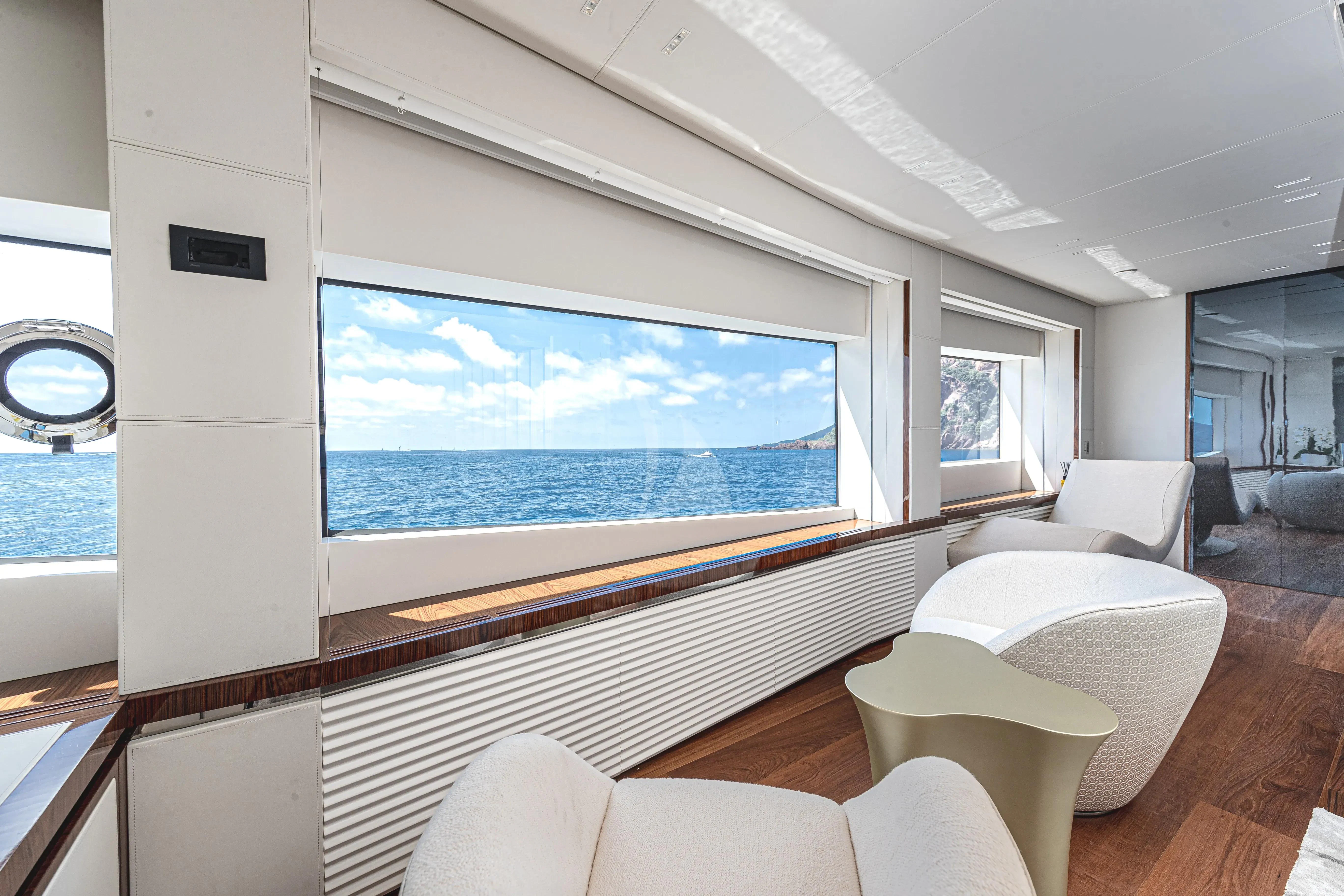 a room with a large window and a view of the ocean aboard LAFAYETTE Yacht for Sale