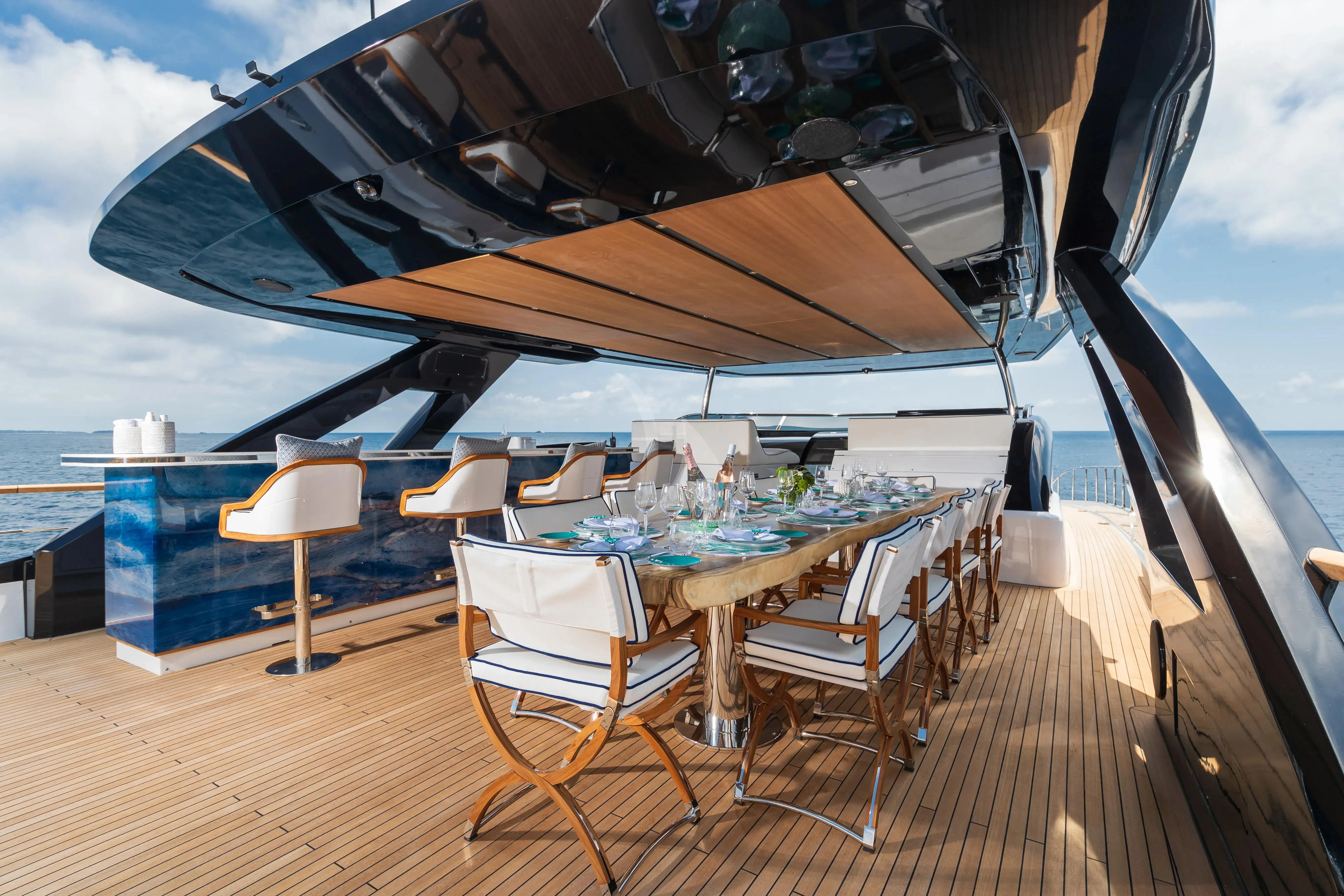 a deck with tables and chairs aboard LAFAYETTE Yacht for Sale