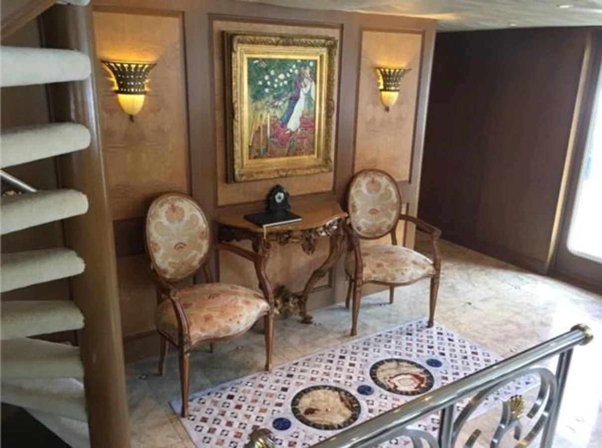 a room with a table and chairs aboard MYC Yacht for Sale