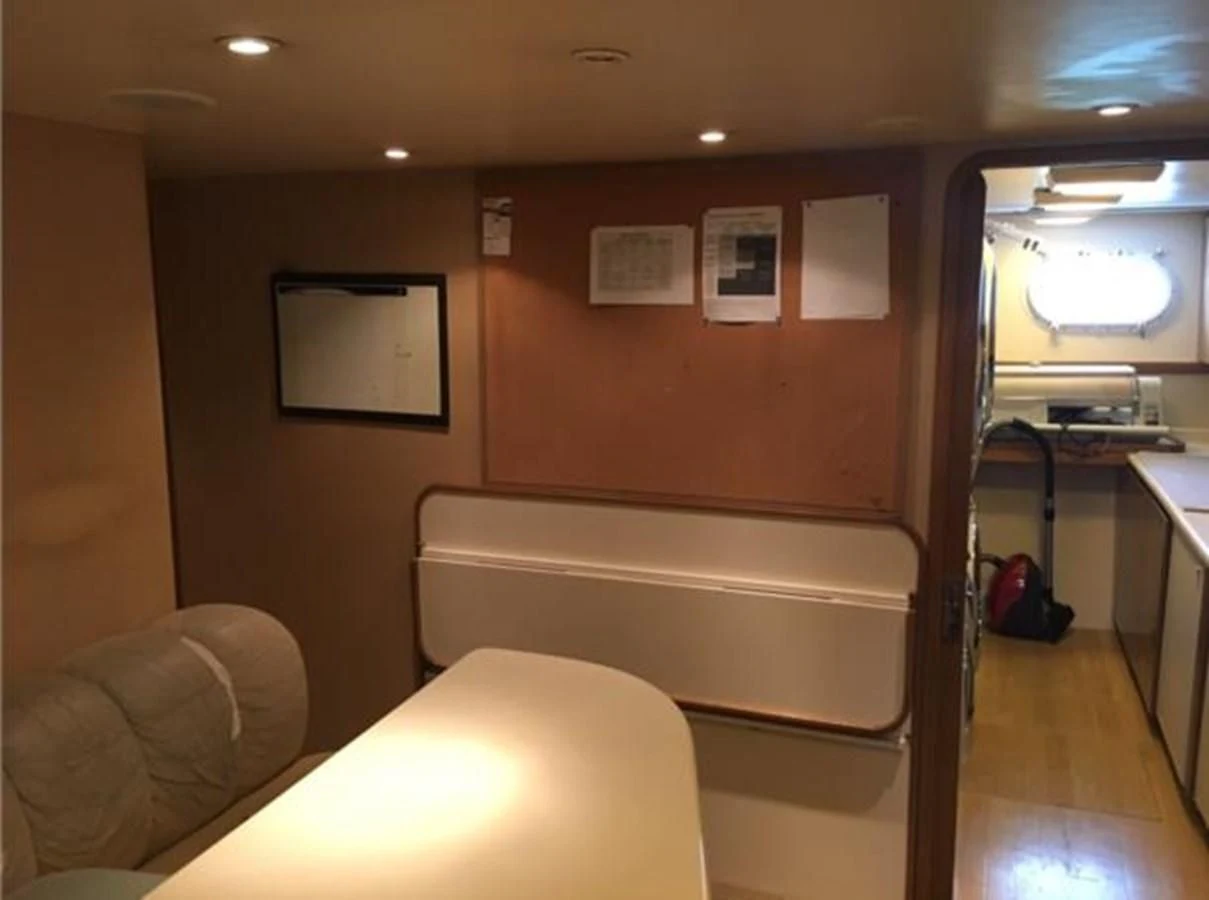 a room with a couch and a television aboard MYC Yacht for Sale