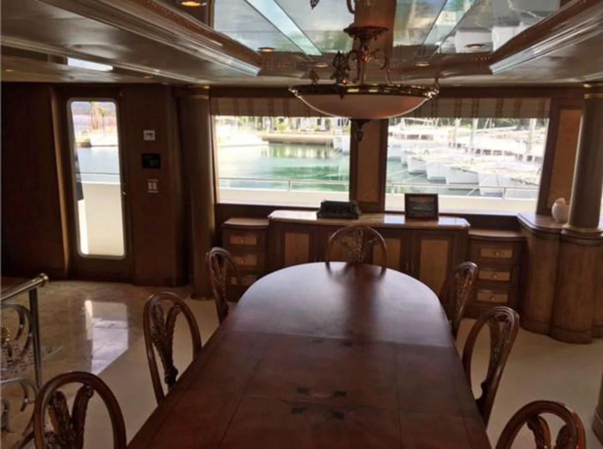 a dining room with a table aboard MYC Yacht for Sale