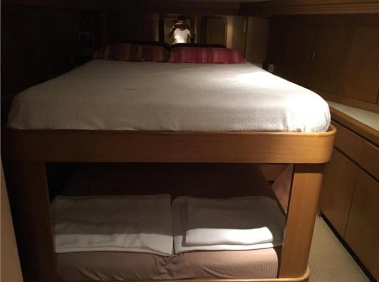 a bed with white sheets aboard MYC Yacht for Sale