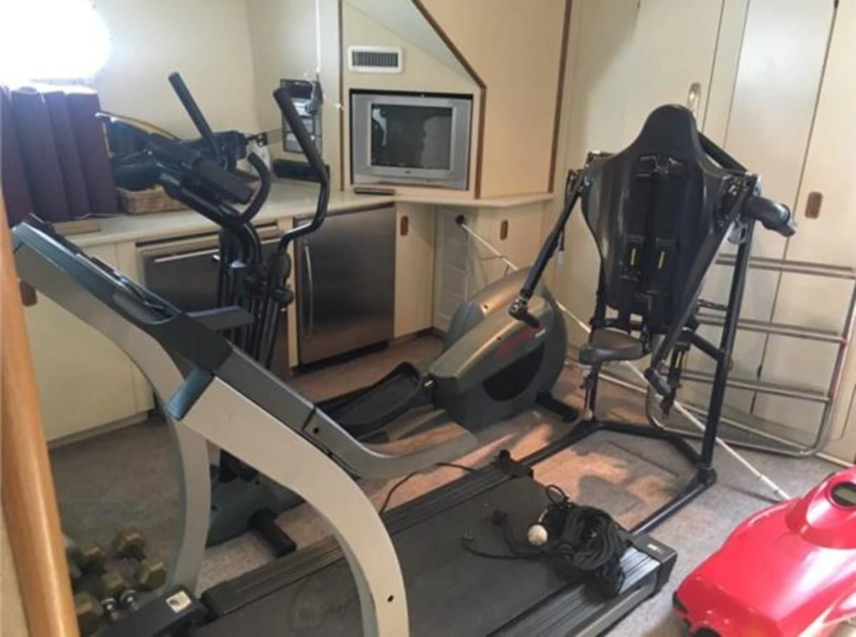 a room with a group of exercise equipment aboard MYC Yacht for Sale