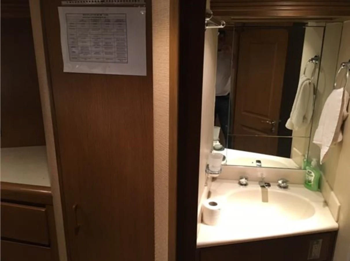 a bathroom with a sink and mirror aboard MYC Yacht for Sale
