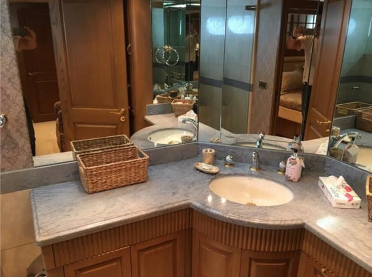 a bathroom with a large mirror aboard MYC Yacht for Sale