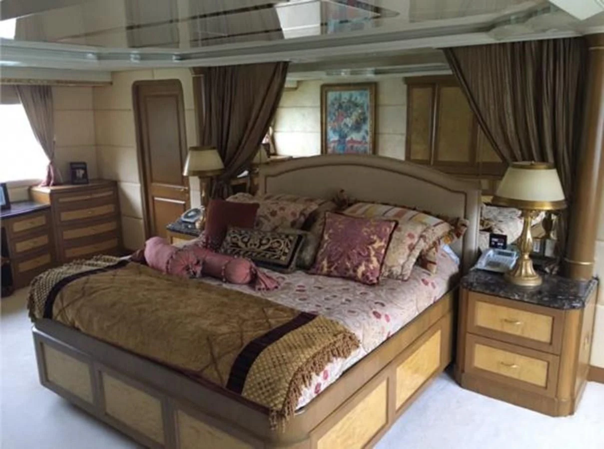 a bedroom with a bed and a lamp aboard MYC Yacht for Sale
