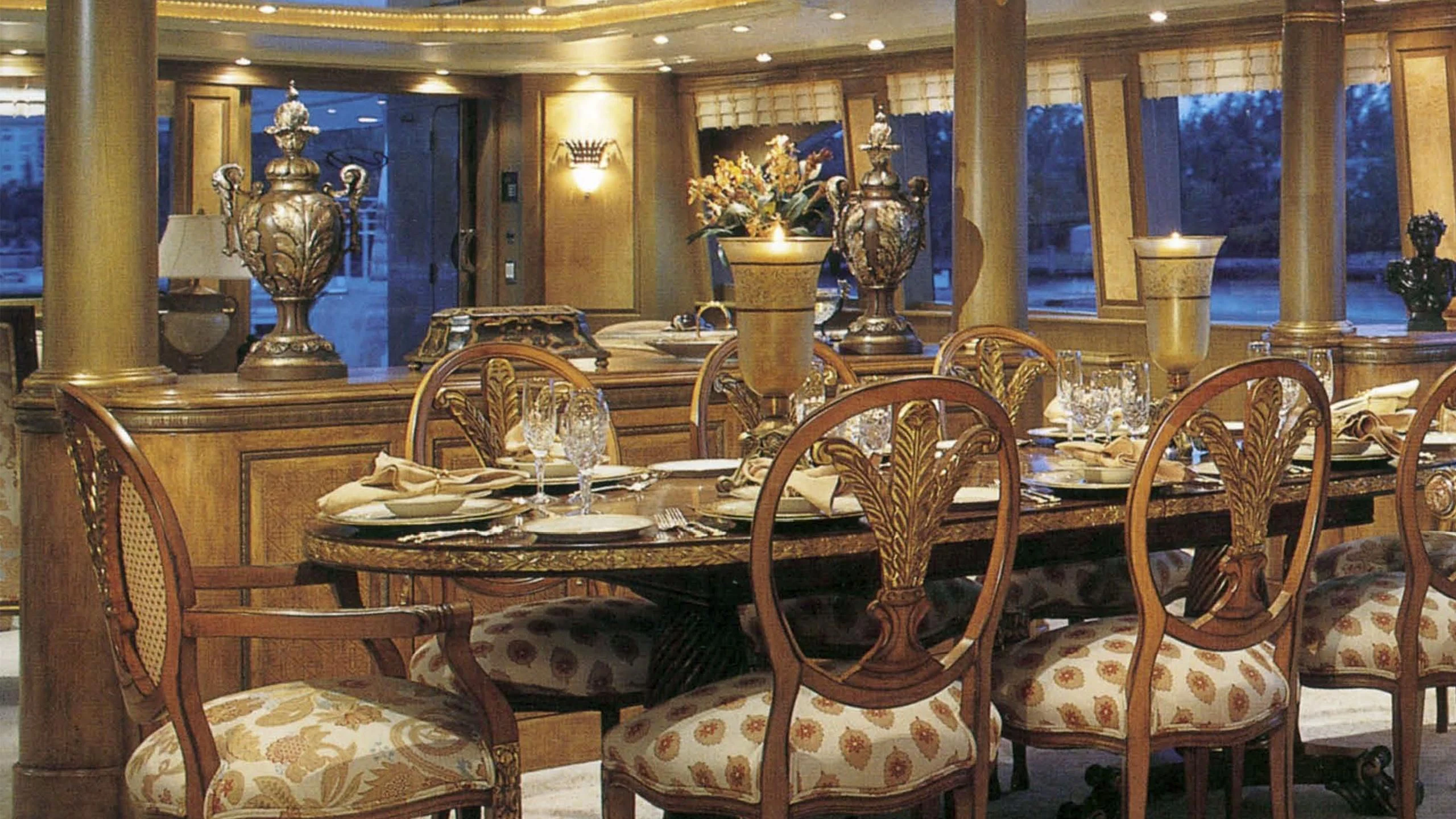 a dining room with a table set aboard MYC Yacht for Sale