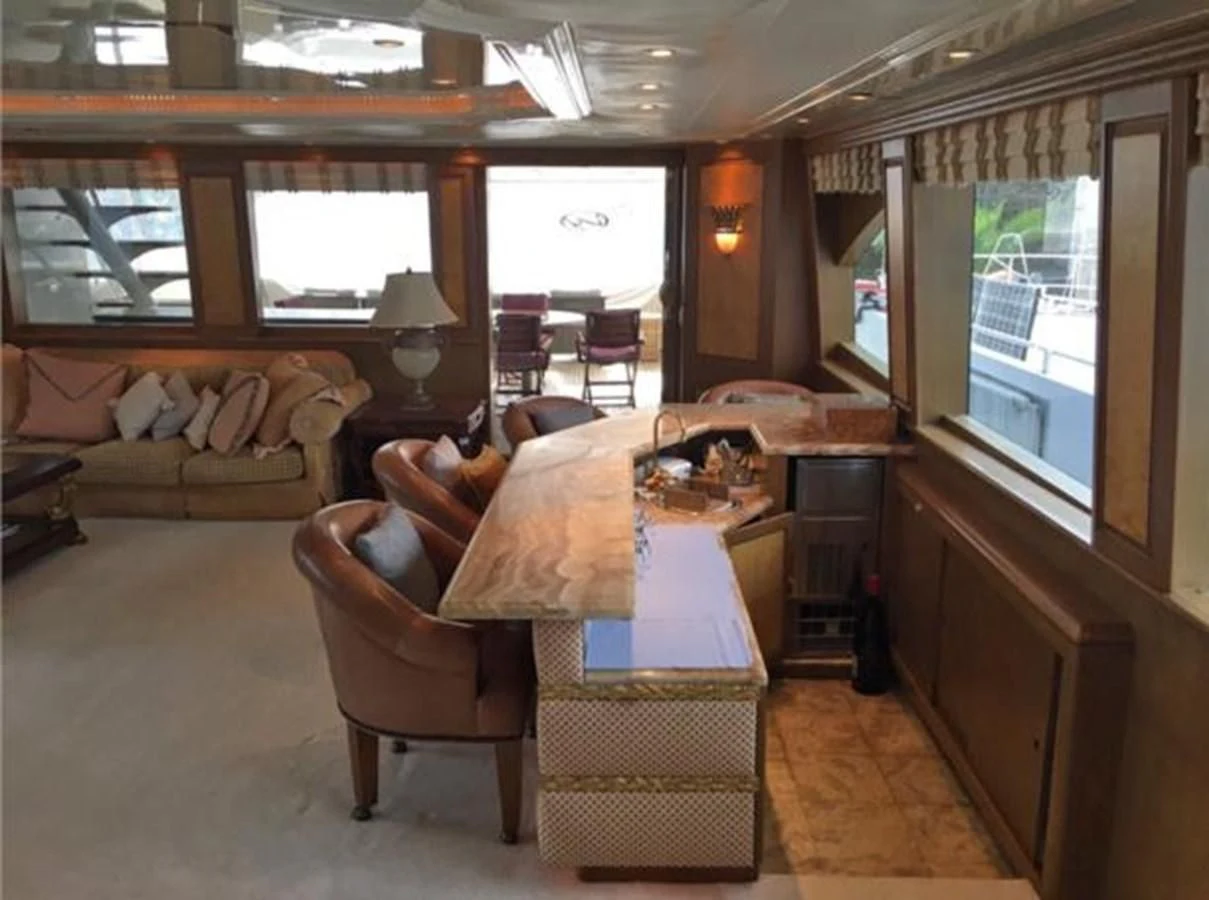a living room with a table and chairs aboard MYC Yacht for Sale