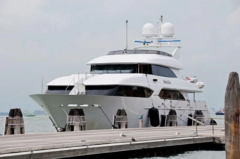 a white yacht on a dock aboard MYC Yacht for Sale