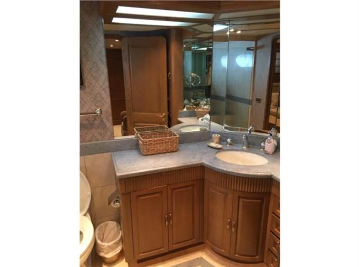 a bathroom with a sink and a mirror aboard MYC Yacht for Sale