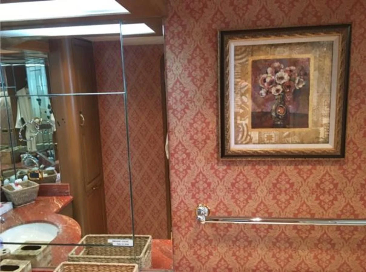 a bathroom with a painting on the wall aboard MYC Yacht for Sale
