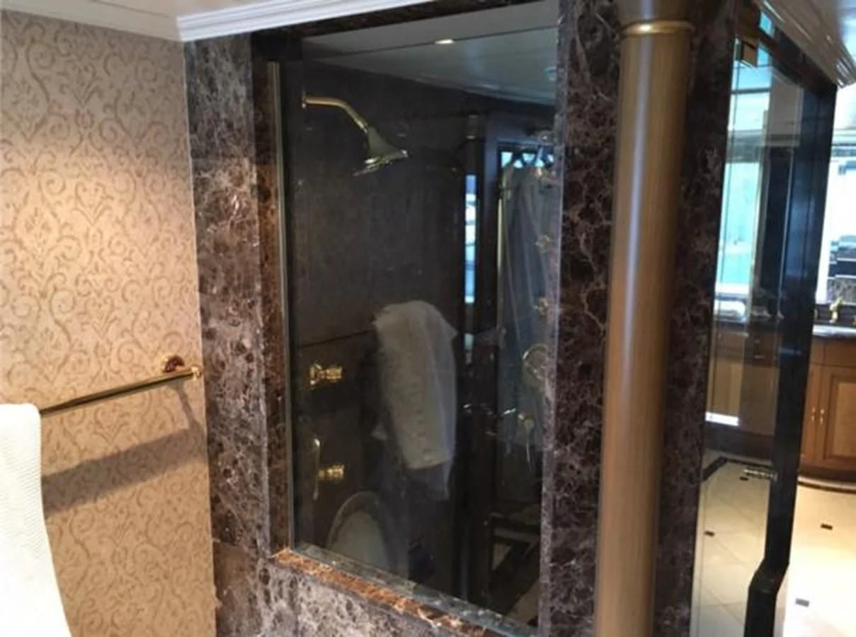 a bathroom with a glass shower aboard MYC Yacht for Sale