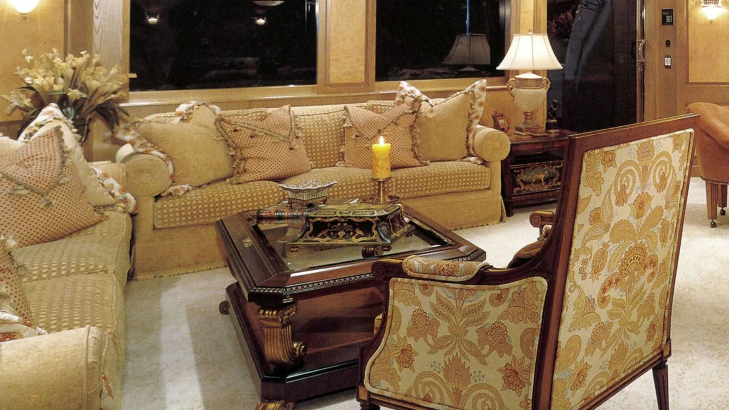 a living room with a couch and a coffee table aboard MYC Yacht for Sale