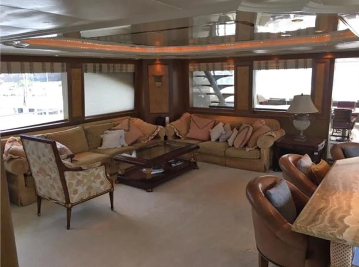 a living room with a couch and a table aboard MYC Yacht for Sale